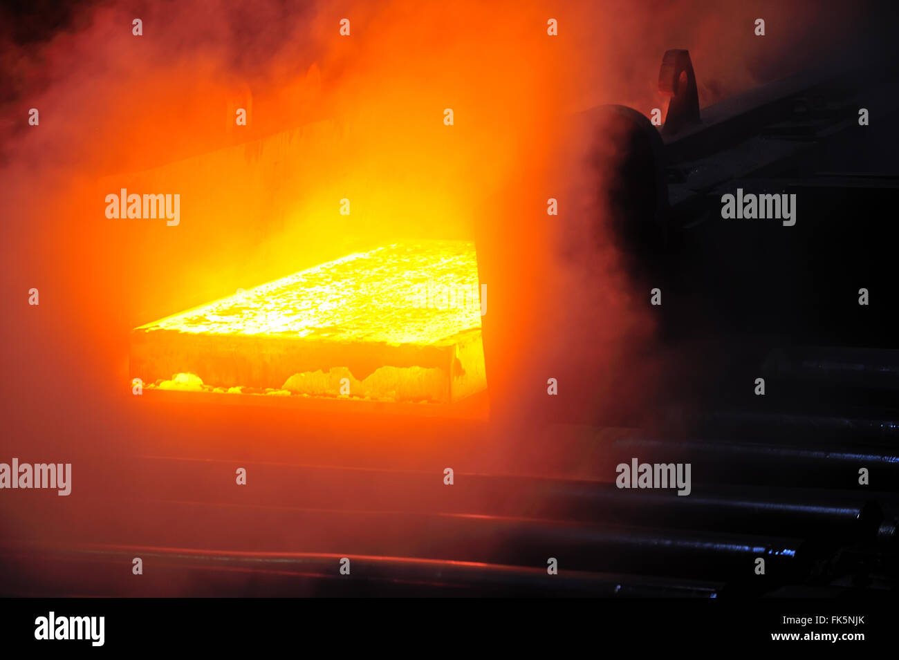 hot steel plate on conveyor in steel mill Stock Photo