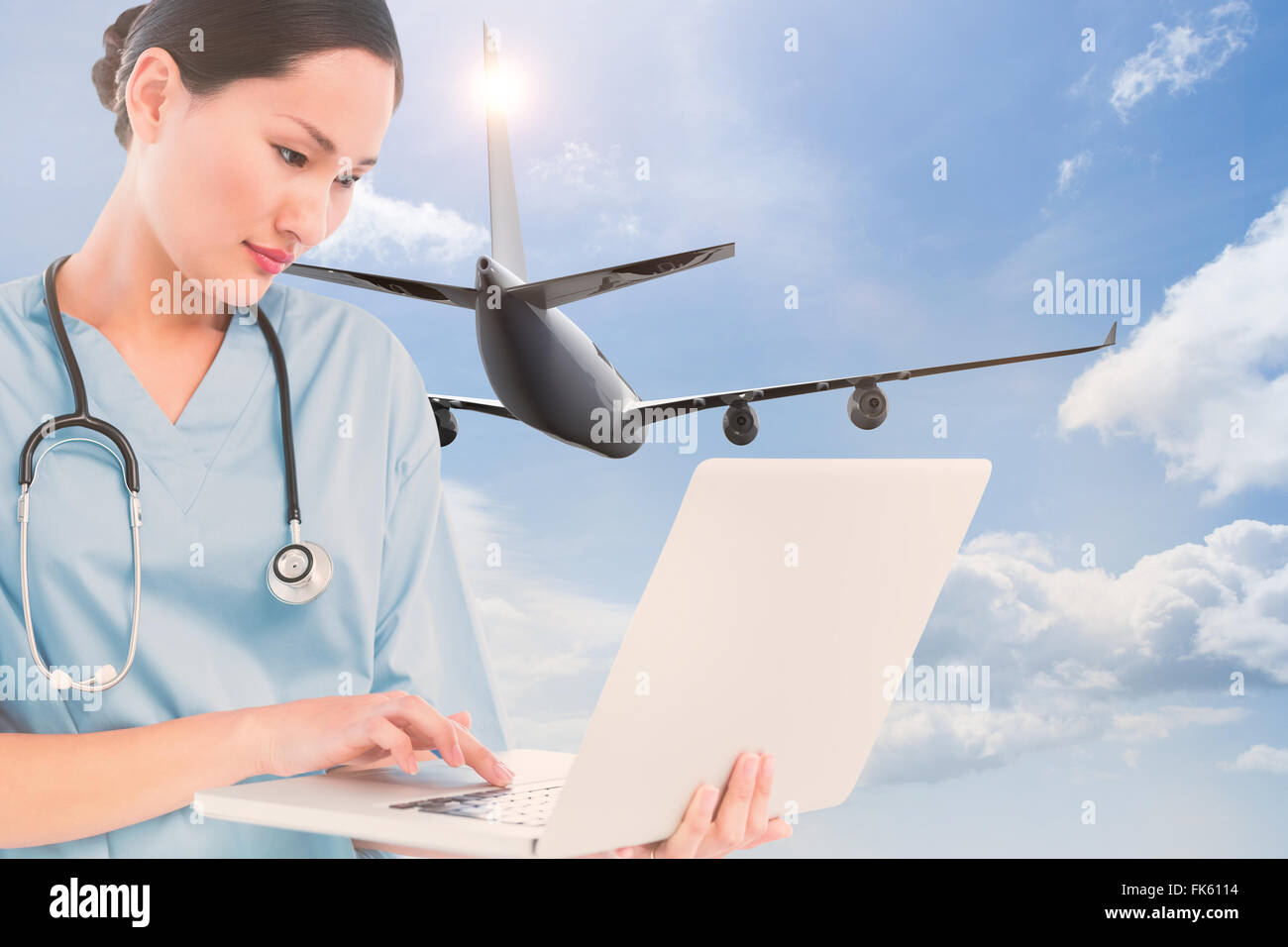 Composite image of concentrated surgeon using a laptop in hospital Stock Photo