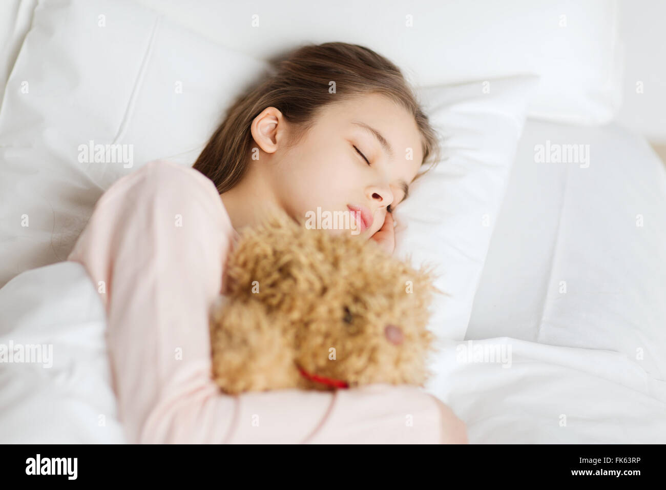 girl sleeping with teddy bear toy in bed at home Stock Photo - Alamy