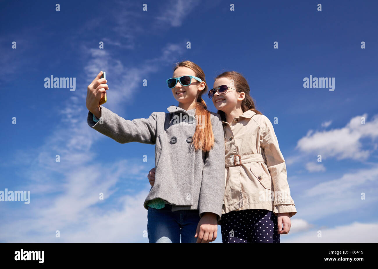 happy girls with smartphone taking selfie outdoors Stock Photo - Alamy