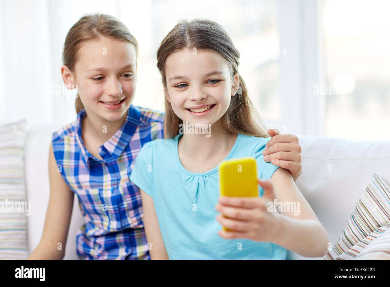 happy girls with smartphone taking selfie at home Stock Photo - Alamy