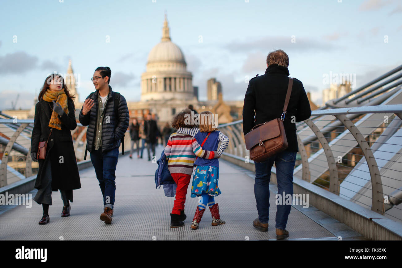 Two friends walk across the Millennium Bridge in London, Britain January 4, 2016. Stock Photo