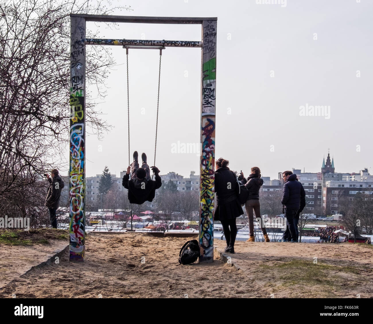 Young man using swing with young woman waiting at Mauerpark, Berlin, Mauer  Public Park, Wall Park Stock Photo - Alamy