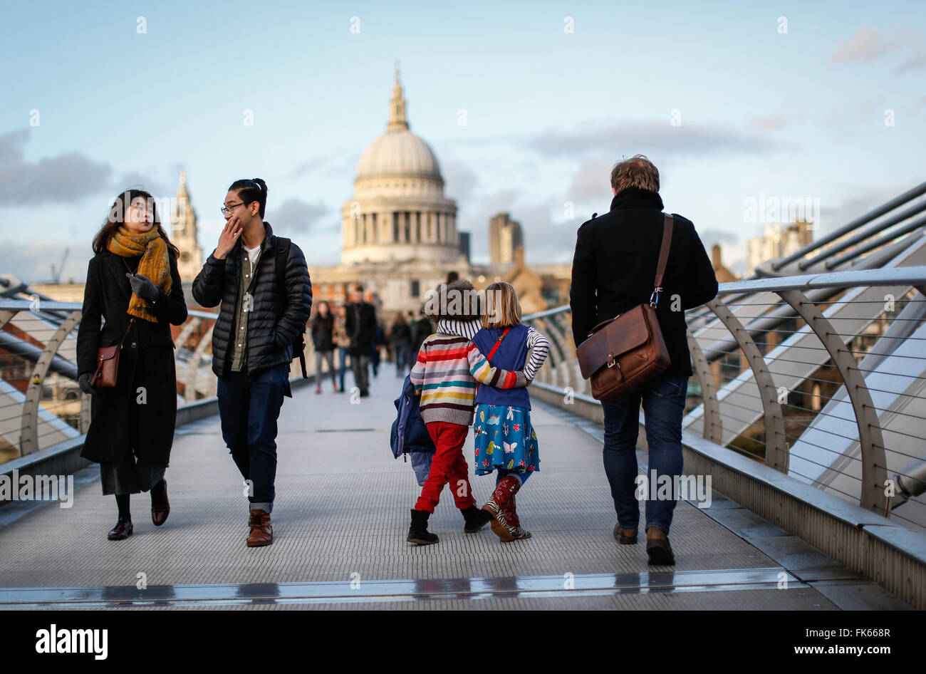 Two friends walk across the Millennium Bridge in London, Britain January 4, 2016. Stock Photo