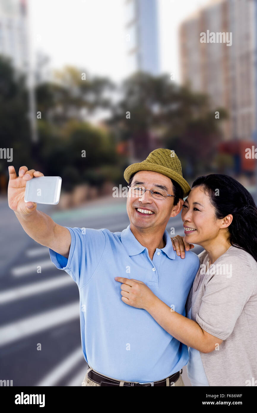 Composite image of man and woman taking a picture Stock Photo