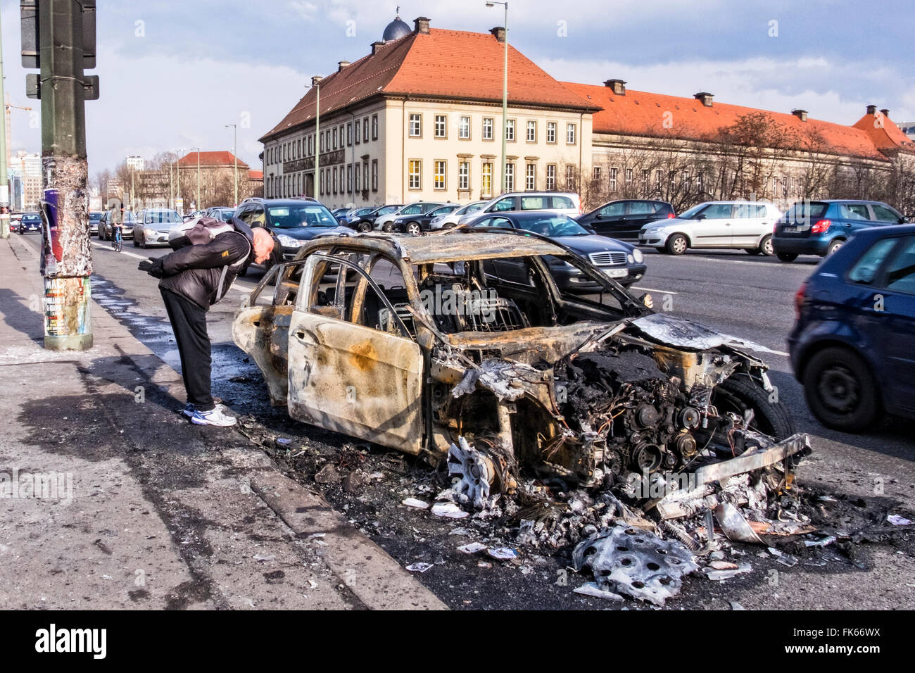 Burnt out, fire damaged car wreck on Berlin street Stock Photo