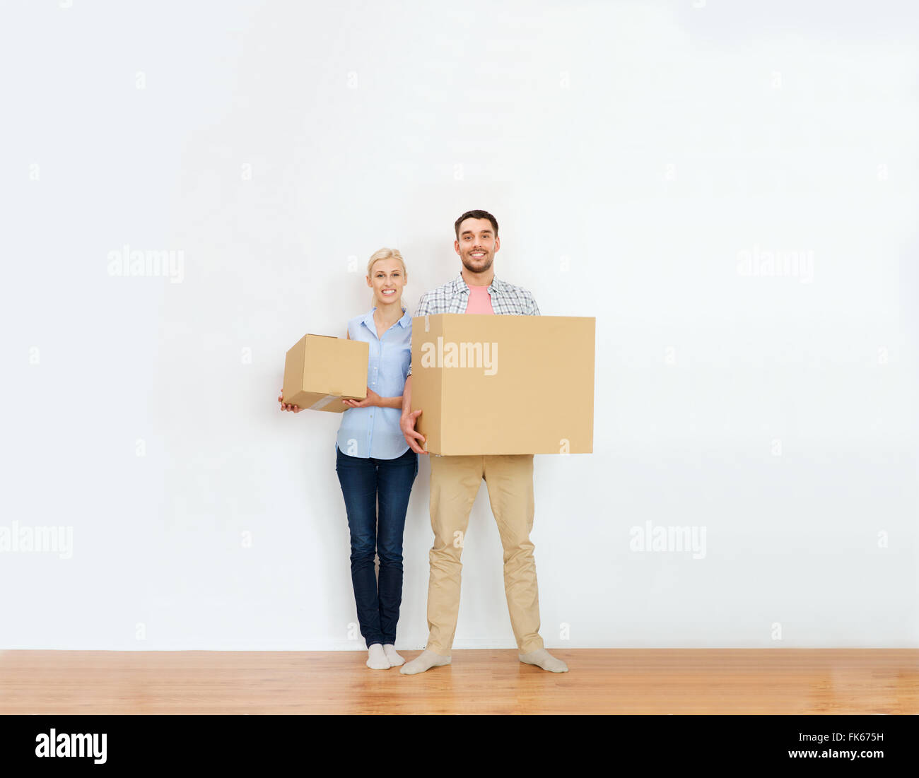 couple with cardboard boxes moving to new home Stock Photo - Alamy