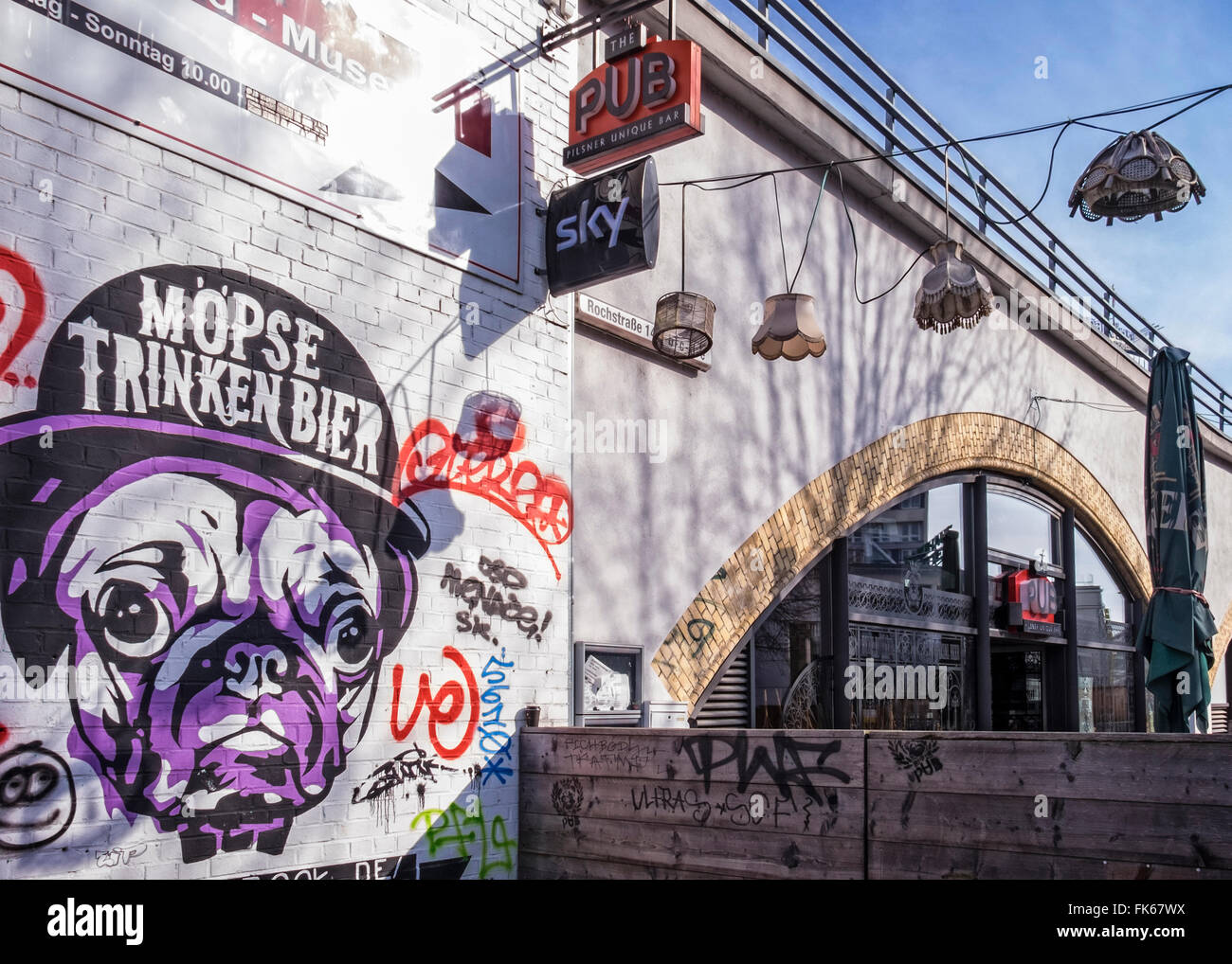 The Pub - Bar under railway bridge with quirky lampshades and bulldog wall art, Mitte, Berlin, Germany Stock Photo