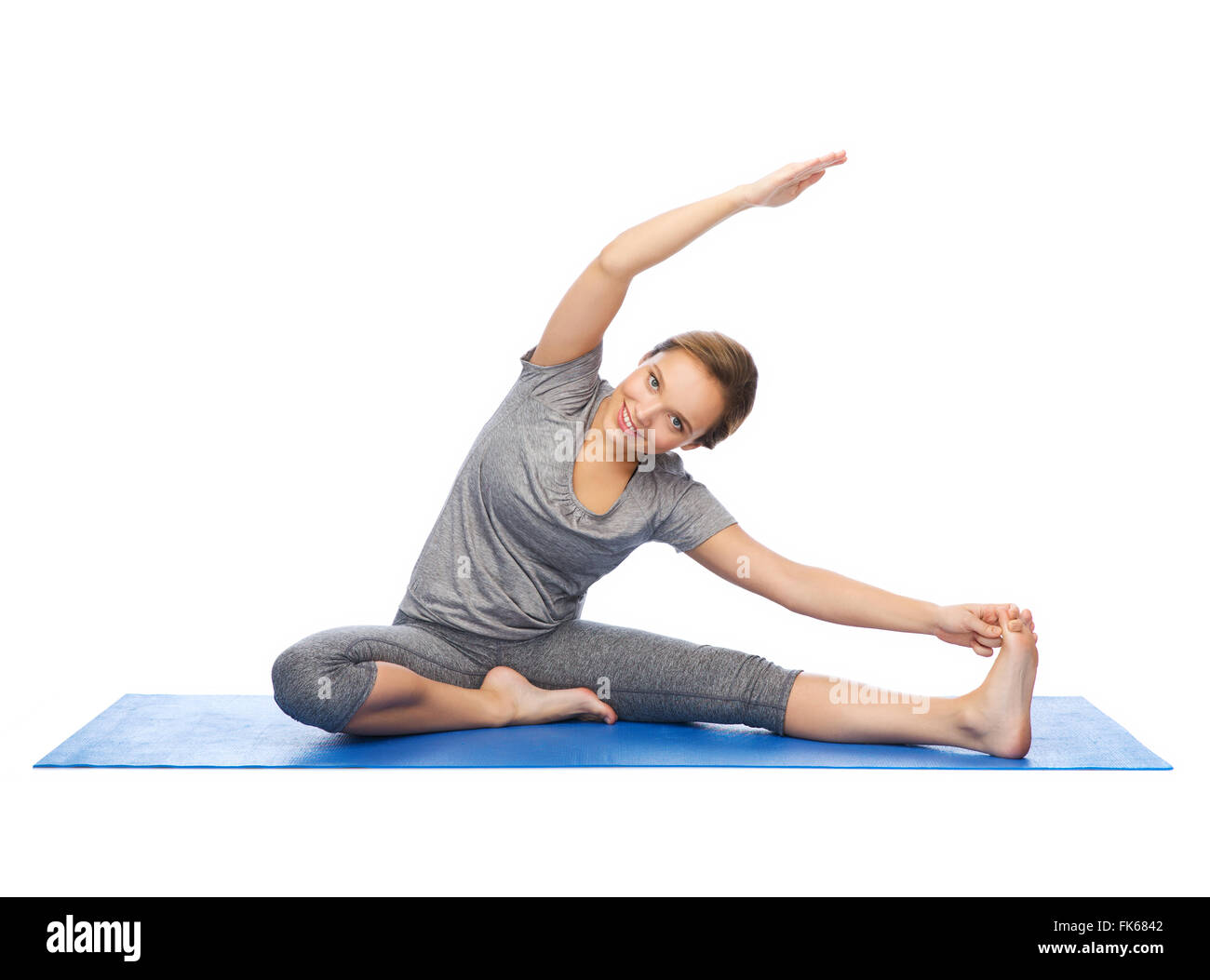 happy woman making yoga and stretching on mat Stock Photo - Alamy