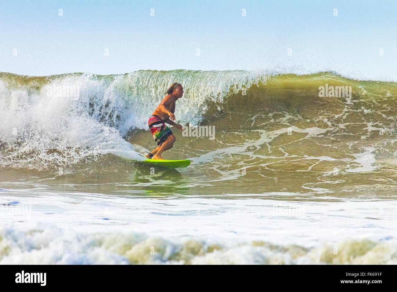 Middle-aged man surfing at this hip resort near Mal Pais, far south of Nicoya Peninsula, Santa Teresa, Puntarenas, Costa Rica Stock Photo