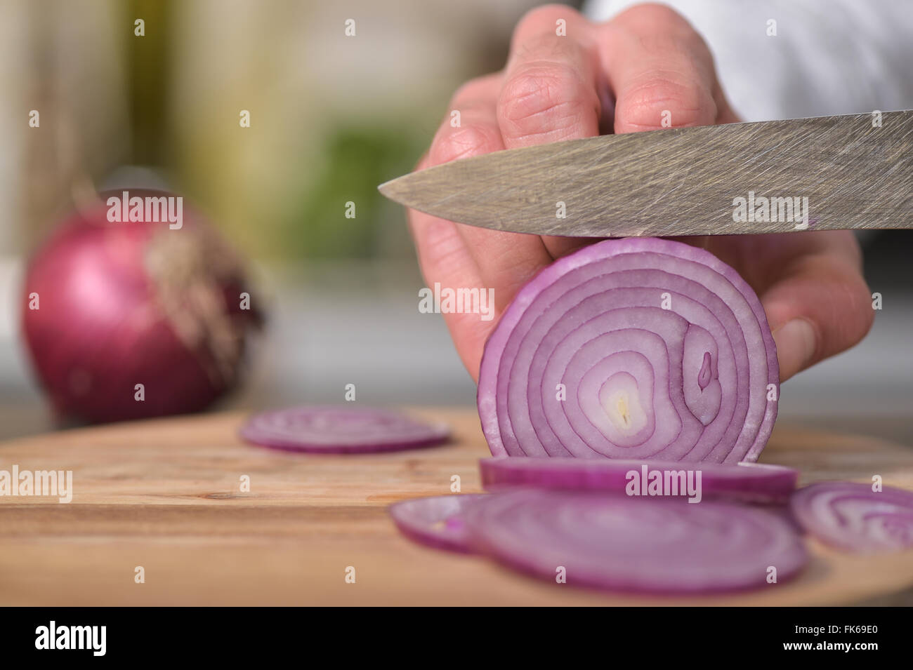 Chef adding dicing onions on table Stock Photo