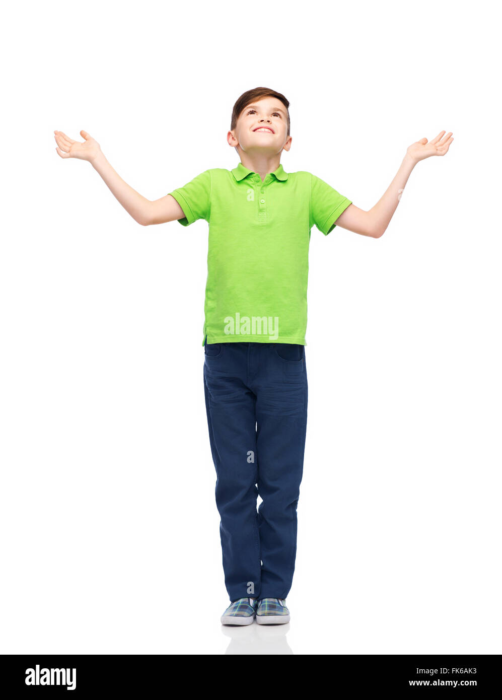 happy boy in polo t-shirt raising hands up Stock Photo - Alamy