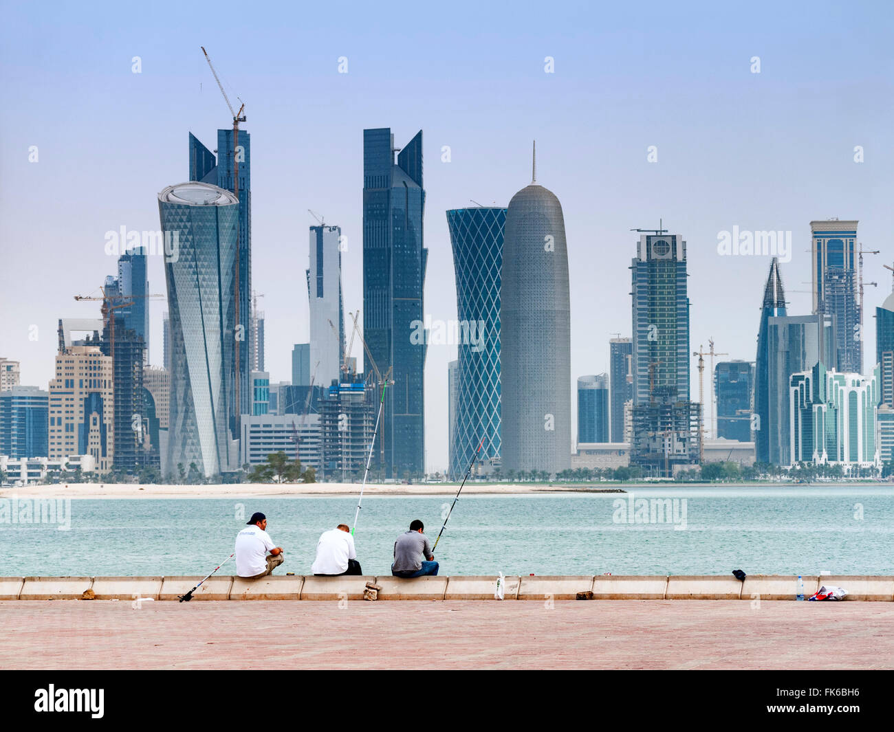 View along waterfront of Corniche towards modern office towers in Doha Qatar Stock Photo