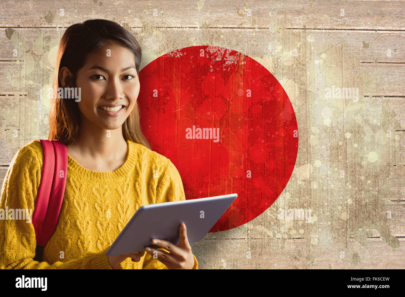 Composite image of smiling asian female student using tablet Stock Photo