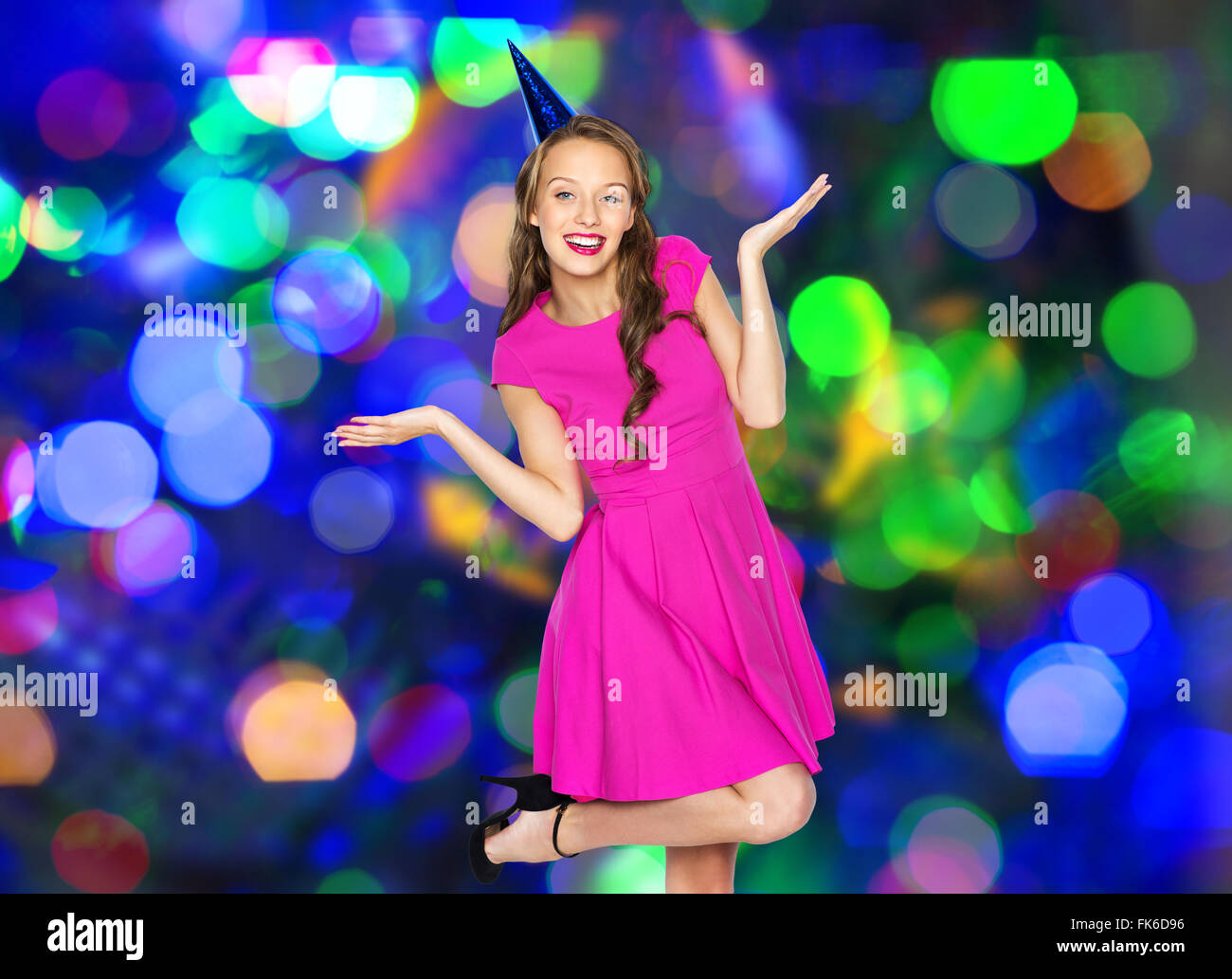 happy young woman or teen girl in party cap Stock Photo - Alamy