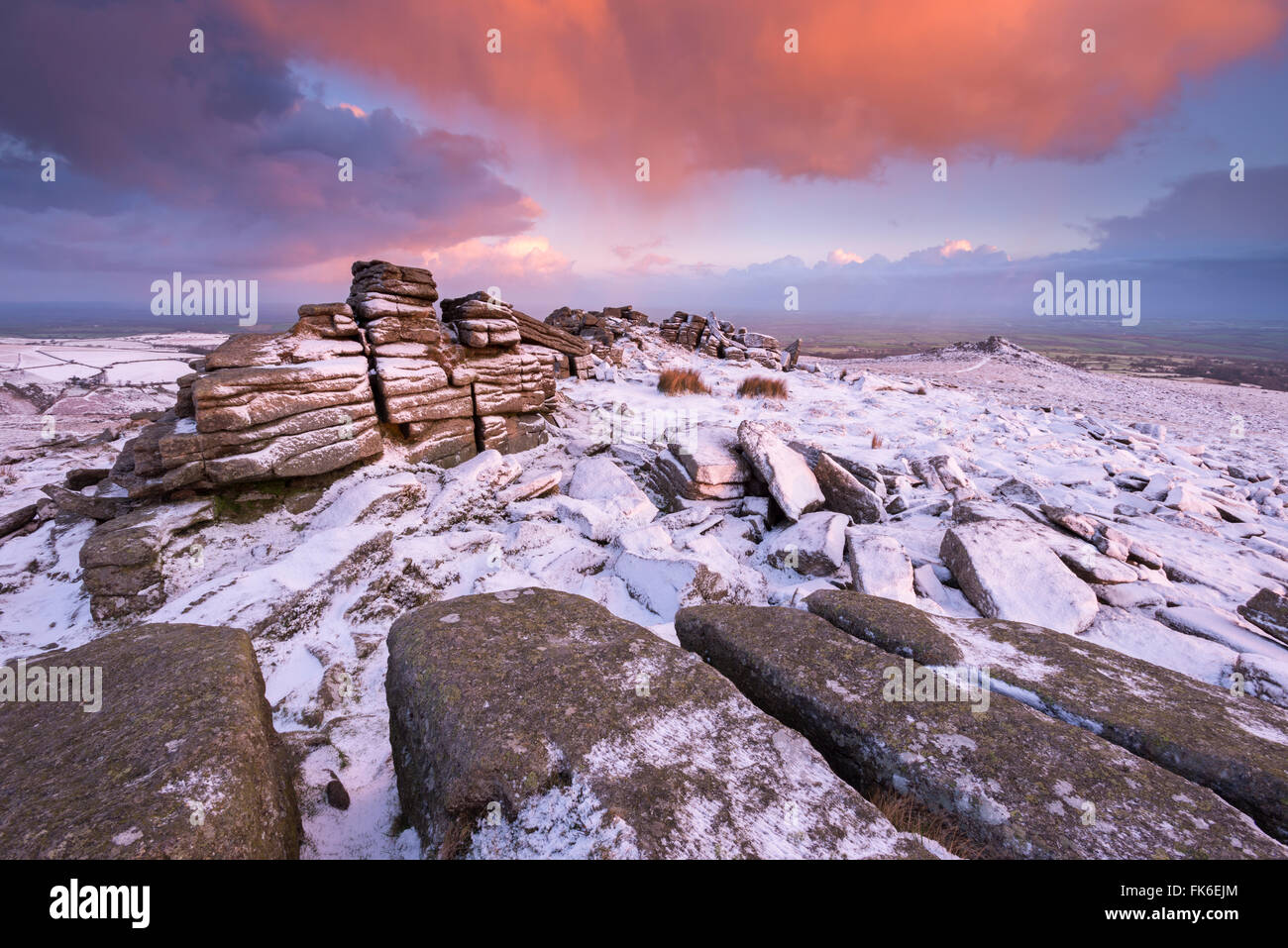 Colourful sunrise above snow covered moorland, Belstone Tor, Dartmoor, Devon, England, United Kingdom, Europe Stock Photo