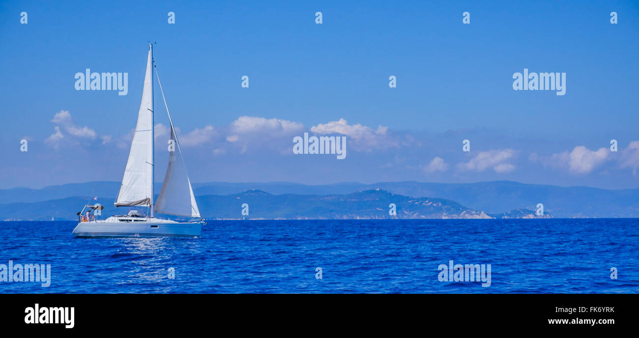 France, Corse, sailing boats in the sea close to the coast Stock Photo