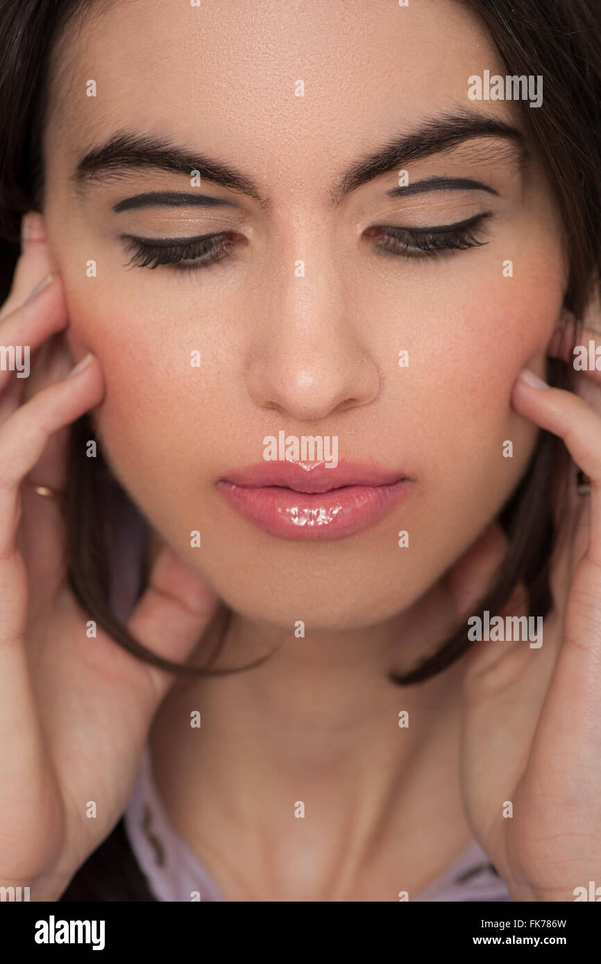 Close up of a dark haired model wearing make up in the studio Stock Photo