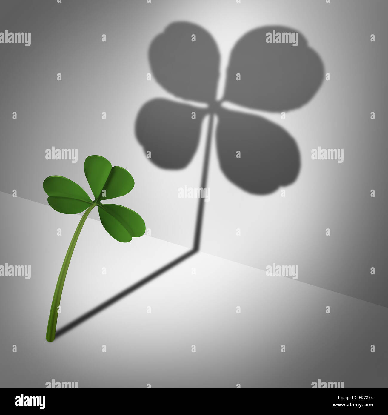 Think positive as an optimistic motvational concept and feeling lucky and positive thinking and inner confidence icon as a three leaf clover casting a shadow with four leaves as a metaphor for optimism and believing in success. Stock Photo