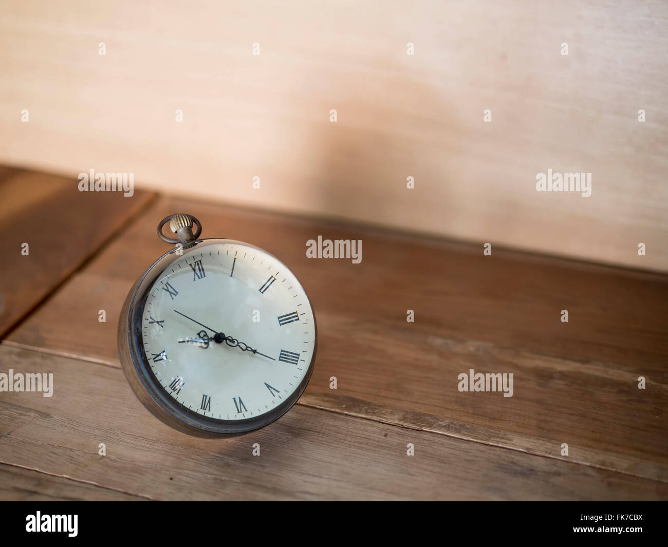Floating clock on wookd background, conceptual image Stock Photo