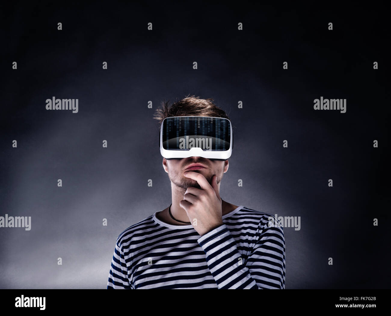 Man wearing virtual reality goggles. Studio shot, black backgrou Stock Photo