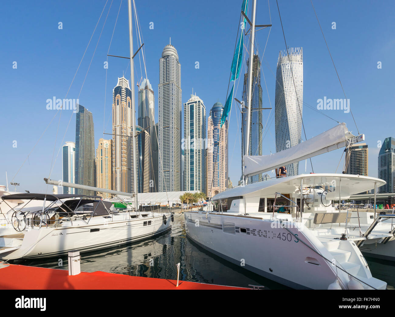 Luxury yachts on display and skyline of skyscrapers on the opening day of the Dubai International Boat Show 2016 . Stock Photo