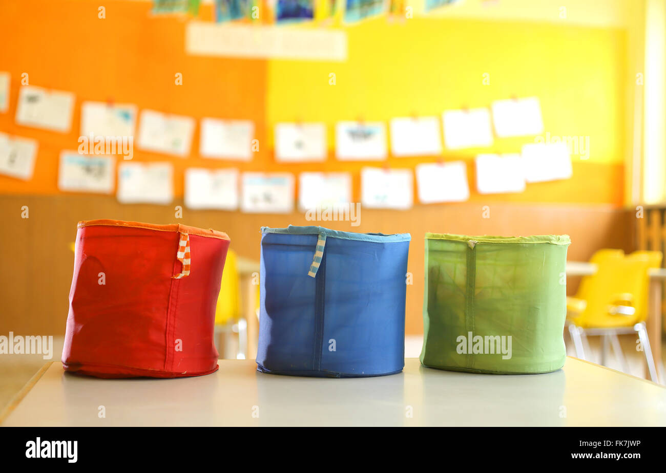 three colored fabric containers for children's toys in the kindergarten classroom Stock Photo