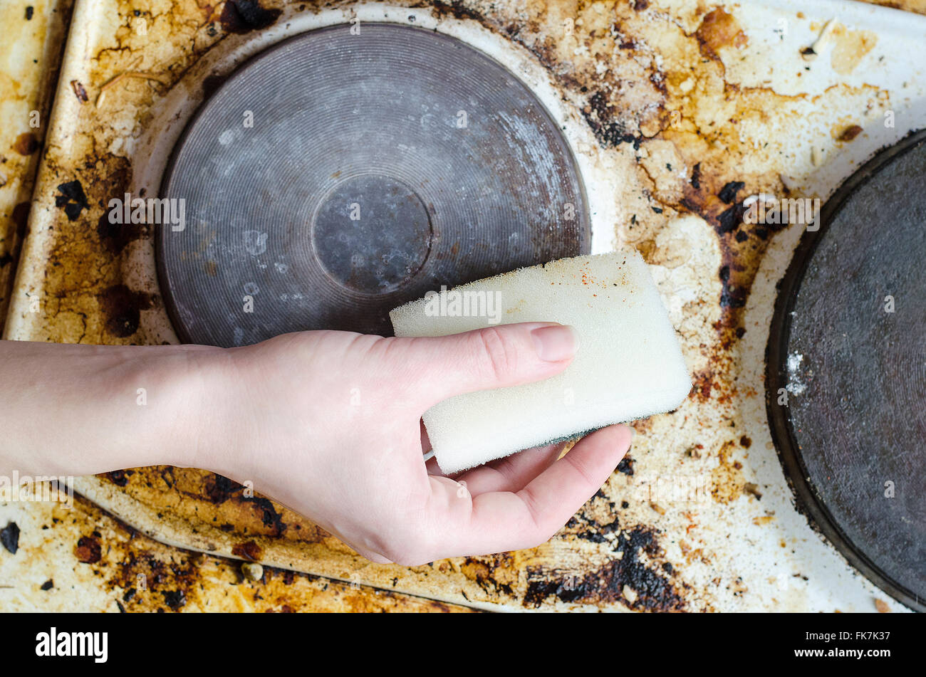 Women hand clean dirty stove Stock Photo Alamy