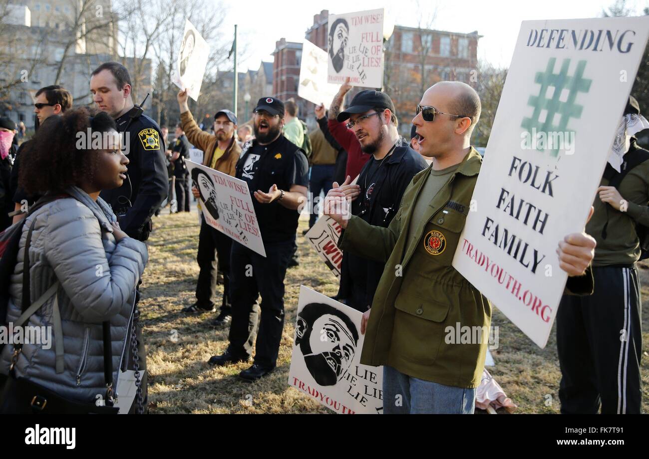 Counter protester Sidney Harris, left, engages with Thomas Buhls during a, 'White Pride' rally outside the IMU. Matthew Heimbach holding sign, is at right behind the police officer. Buhls and Heimbach are part of a group called the Traditional Youth Network, and when referred to as white supremacists say they prefer the titled, 'White Nationalists.' Heimbach was recently involved in an incident shoving a black woman at a Donald Trump presidential campaign rally in Louisville, Kentucky. Stock Photo