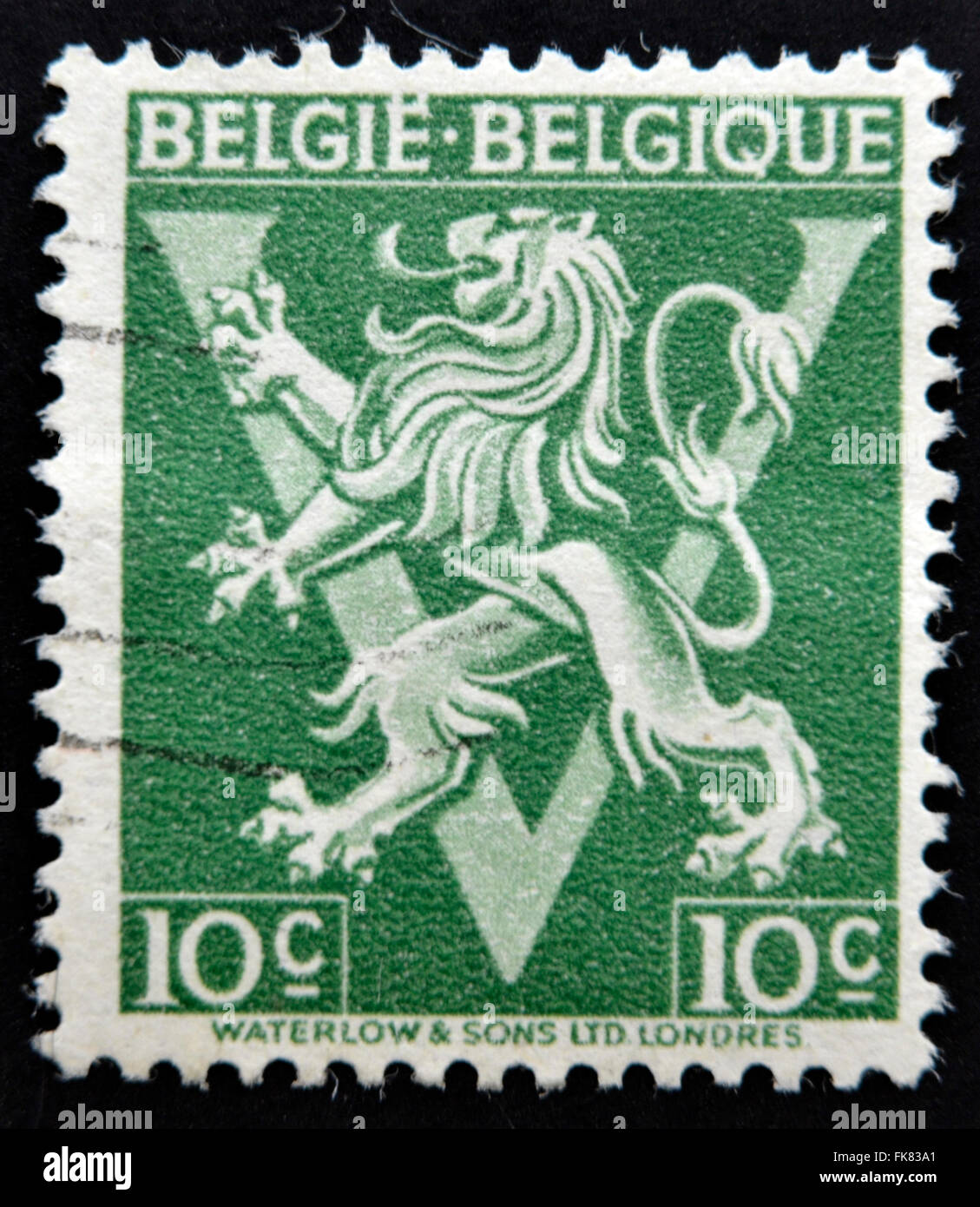 BELGIUM - CIRCA 1946: A stamp printed in Belgium shows The coat of arms of the Kingdom of Belgium bears a lion or Leo Belgium, c Stock Photo