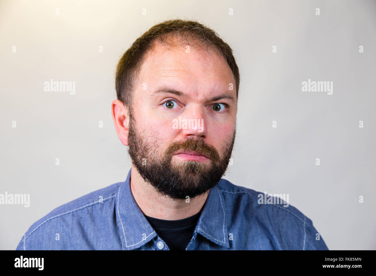 Man In His Mid-30's Poses For A Studio Portrait With A Semi White ...