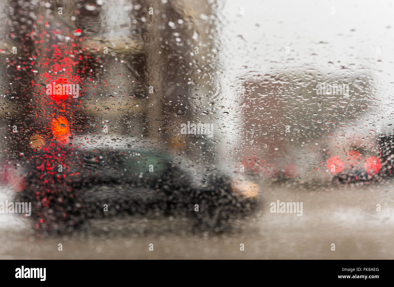 Road view through car window with rain drops and melting snow, Driving ...