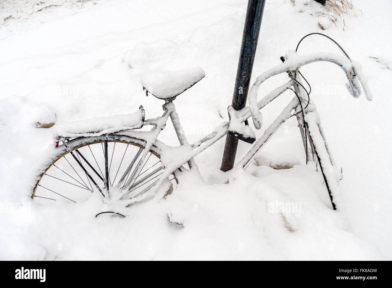 Bike covered in snow during snow storm Stock Photo