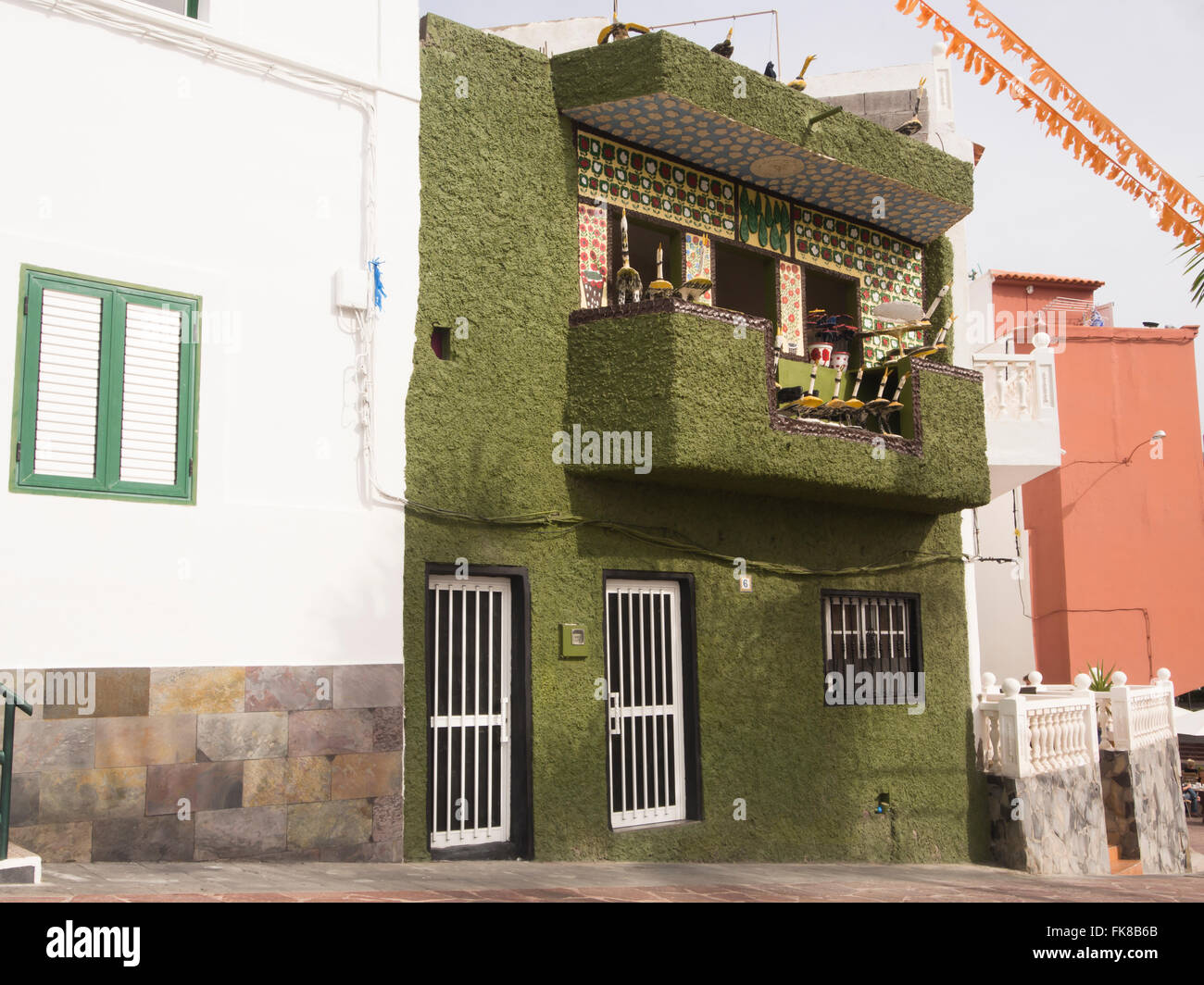 Unique green concrete building facade with balcony in the town Alcala, Tenerife Canary Islands Spain Stock Photo