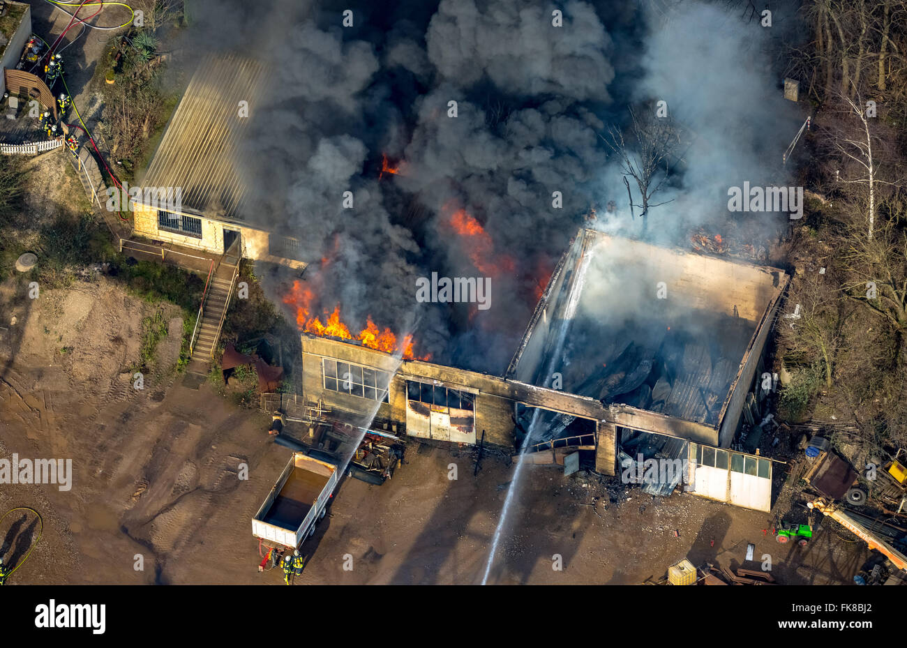 Firefighting operations, warehouse fire at Terra-Gravel, Pulheim near Cologne, Rhineland, North Rhine-Westphalia, Germany Stock Photo