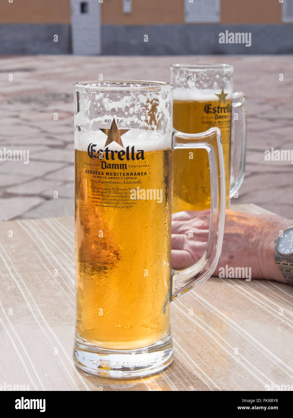 Estrella Damm pilsner beer, fresh and cold, in glass mugs on a pavement  café in Alcala Tenerife Canary Islands Spain Stock Photo - Alamy