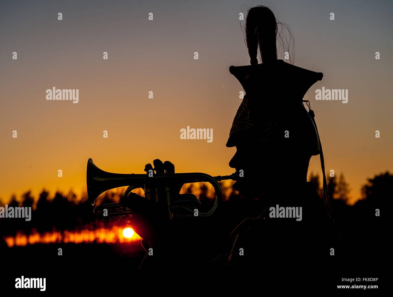 The Divisional Cemetery, Ypres, Belgium - A Military bugler playing The Last Post at sunset in memory of fallen soldiers of World War One Stock Photo