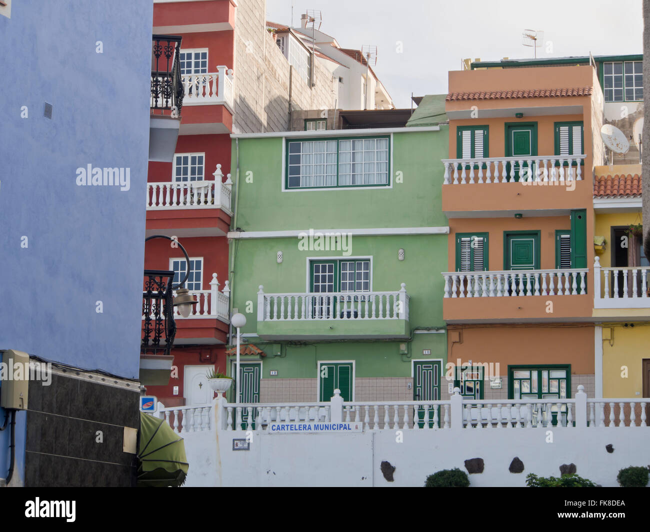 Colourful apartment blocks in Puerto de Santiago on the west coast of Tenerife Canary islands Spain Stock Photo