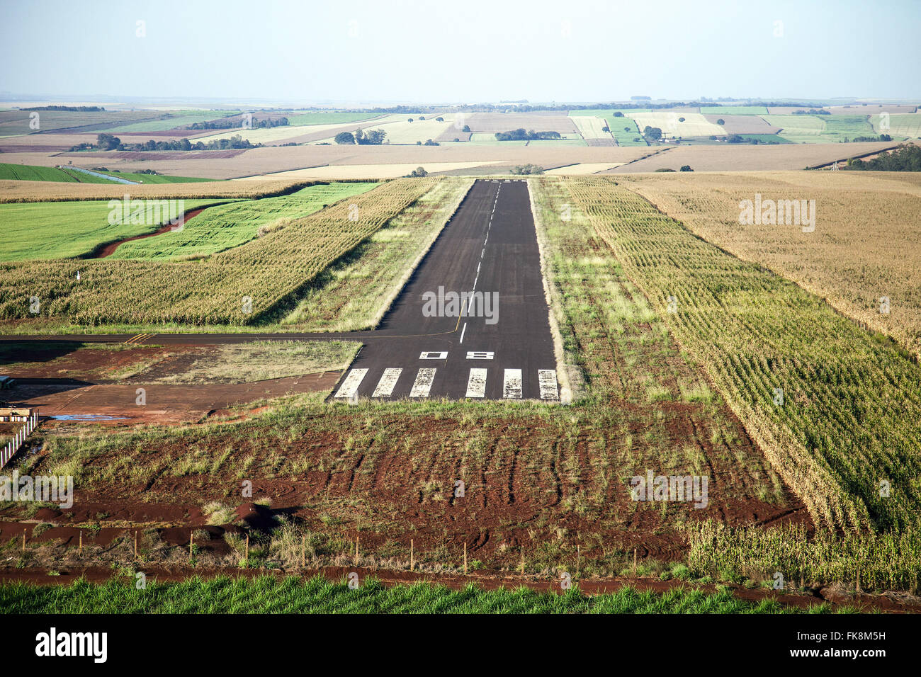 Aerial view of small track through the plantations of sugarcane and grains airport in rural Stock Photo