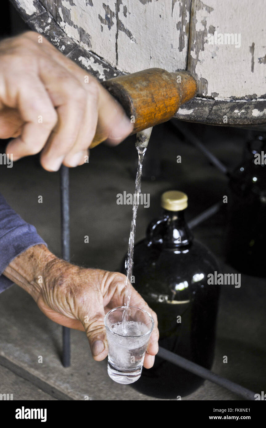 Withdrawal of cachaca in the barrel cane mill for tasting - region of Serra da Mantiqueira Stock Photo