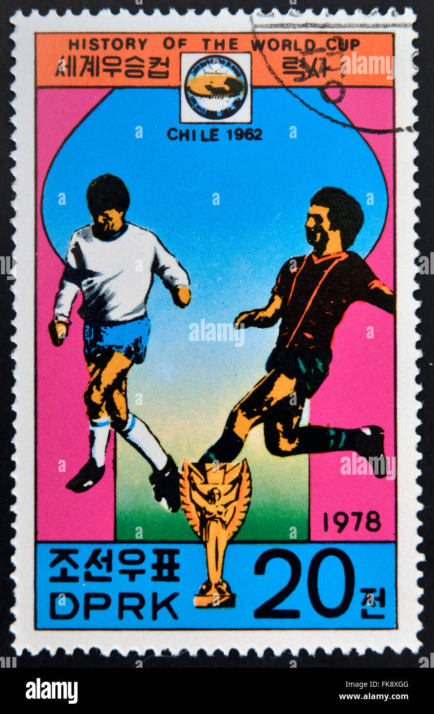 KOREA - CIRCA 1978: A Stamp printed in North Korea shows the Soccer players, Cup and Glob with the inscription 'Chile, 1962' Stock Photo