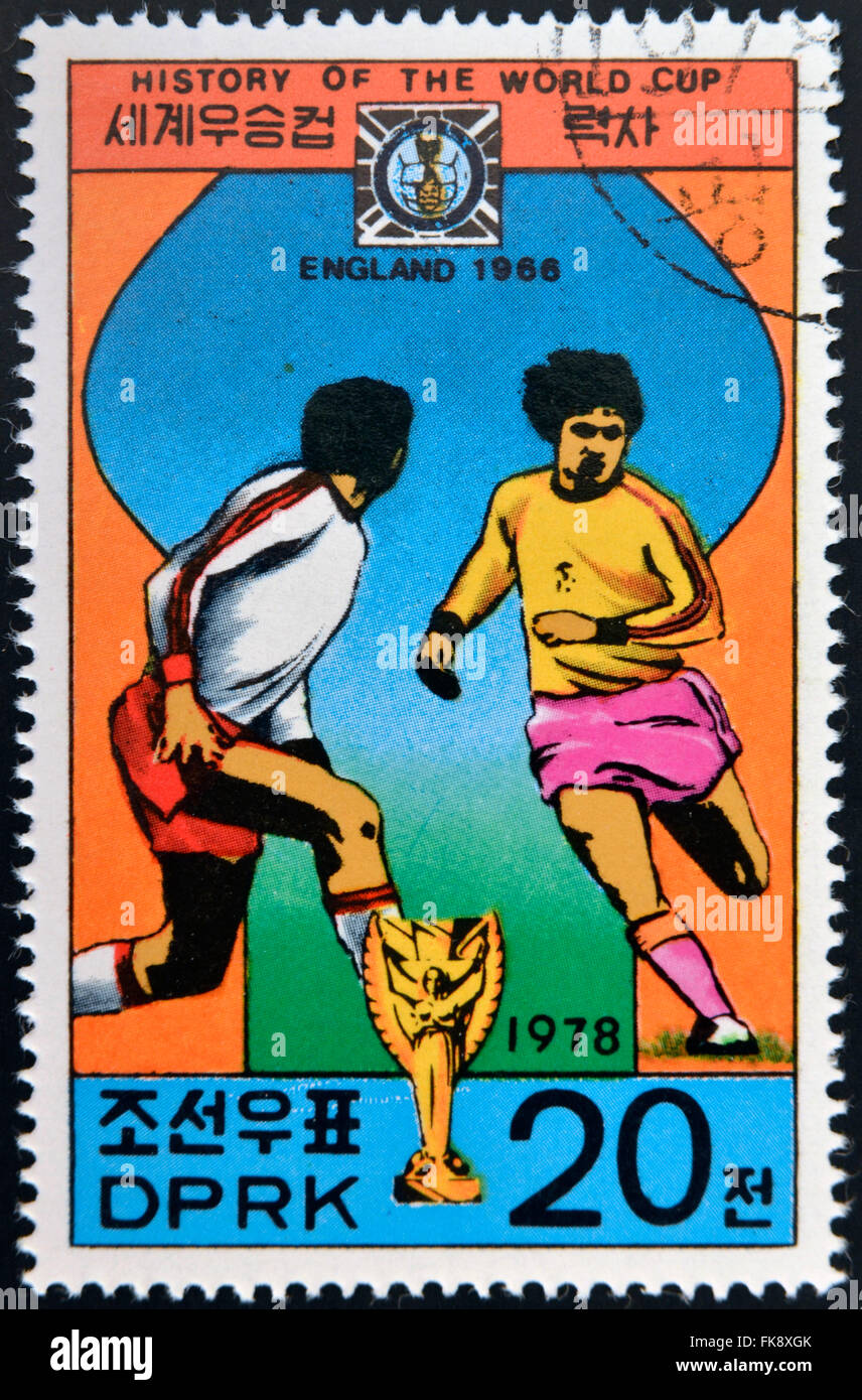 KOREA - CIRCA 1978: A Stamp printed in North Korea shows the Soccer players, Cup and Glob with the inscription 'England, 1966' Stock Photo