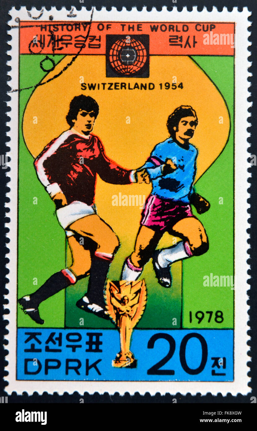 KOREA - CIRCA 1978: A Stamp printed in North Korea shows the Soccer players, Cup and Glob with the inscription Switzerland, 1954 Stock Photo