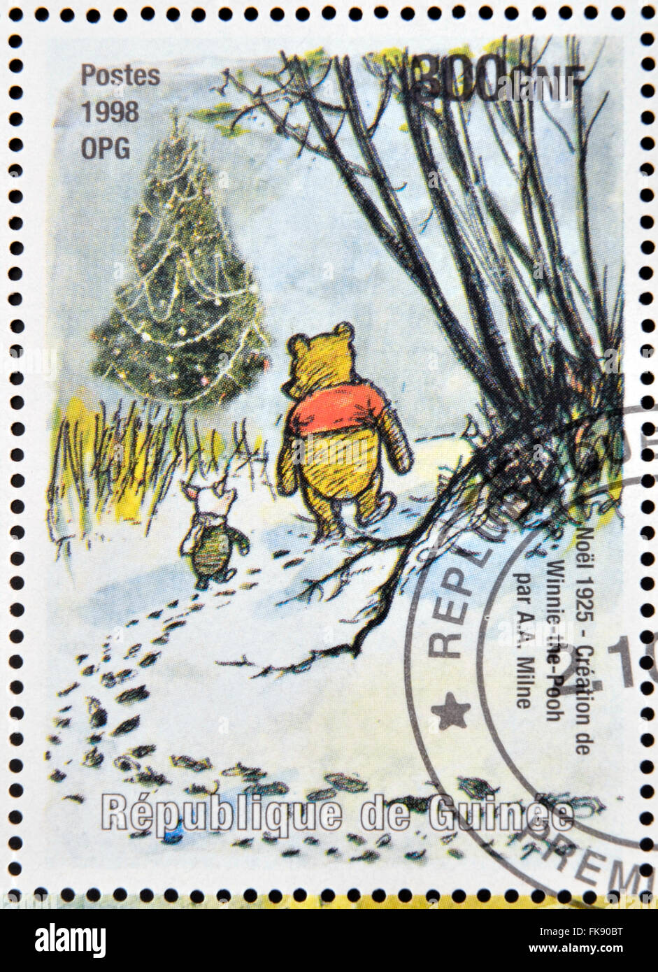 GUINEA - CIRCA 1998: a stamp printed in Republic of Guinea commemorates the creation of Winnie the Pooh by Milne, circa 1998. Stock Photo