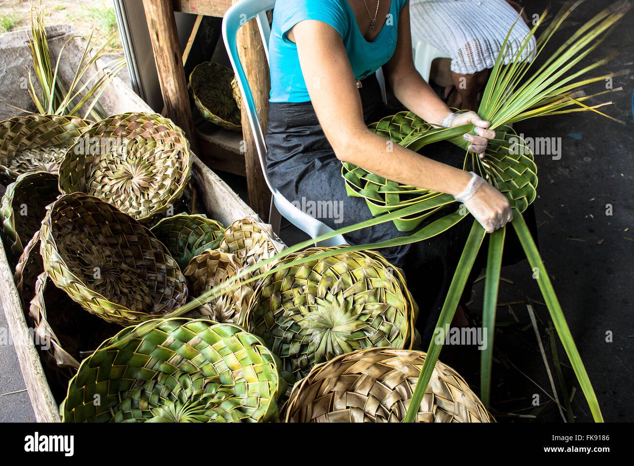 Artesa making basket with greens during the XVII Festival of Traditional Culture Paulista Stock Photo