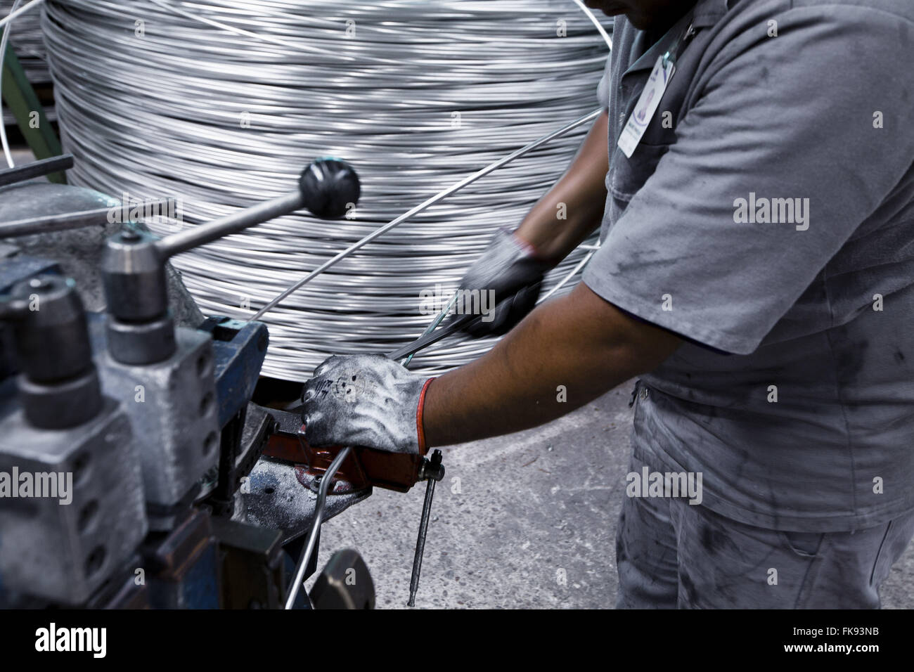 Detail of laborer working on aluminum cables industry Stock Photo