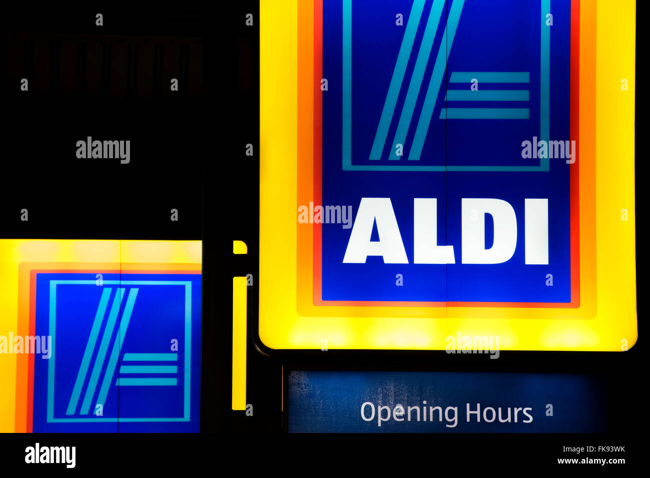Lit up Aldi shop signs at night Stock Photo