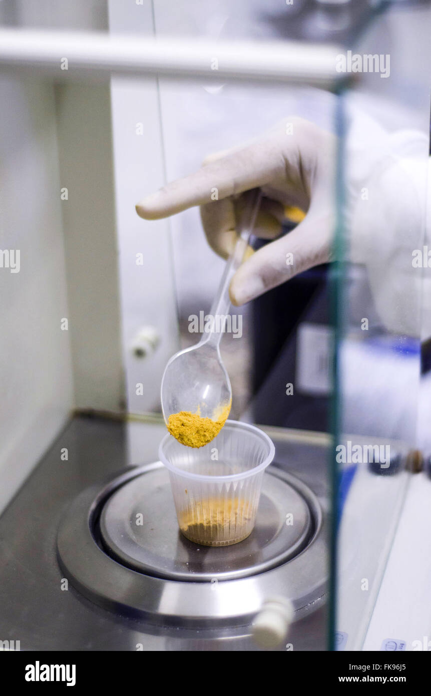 Weighing pharmaceutical raw material in precision scale for production of medicines Stock Photo