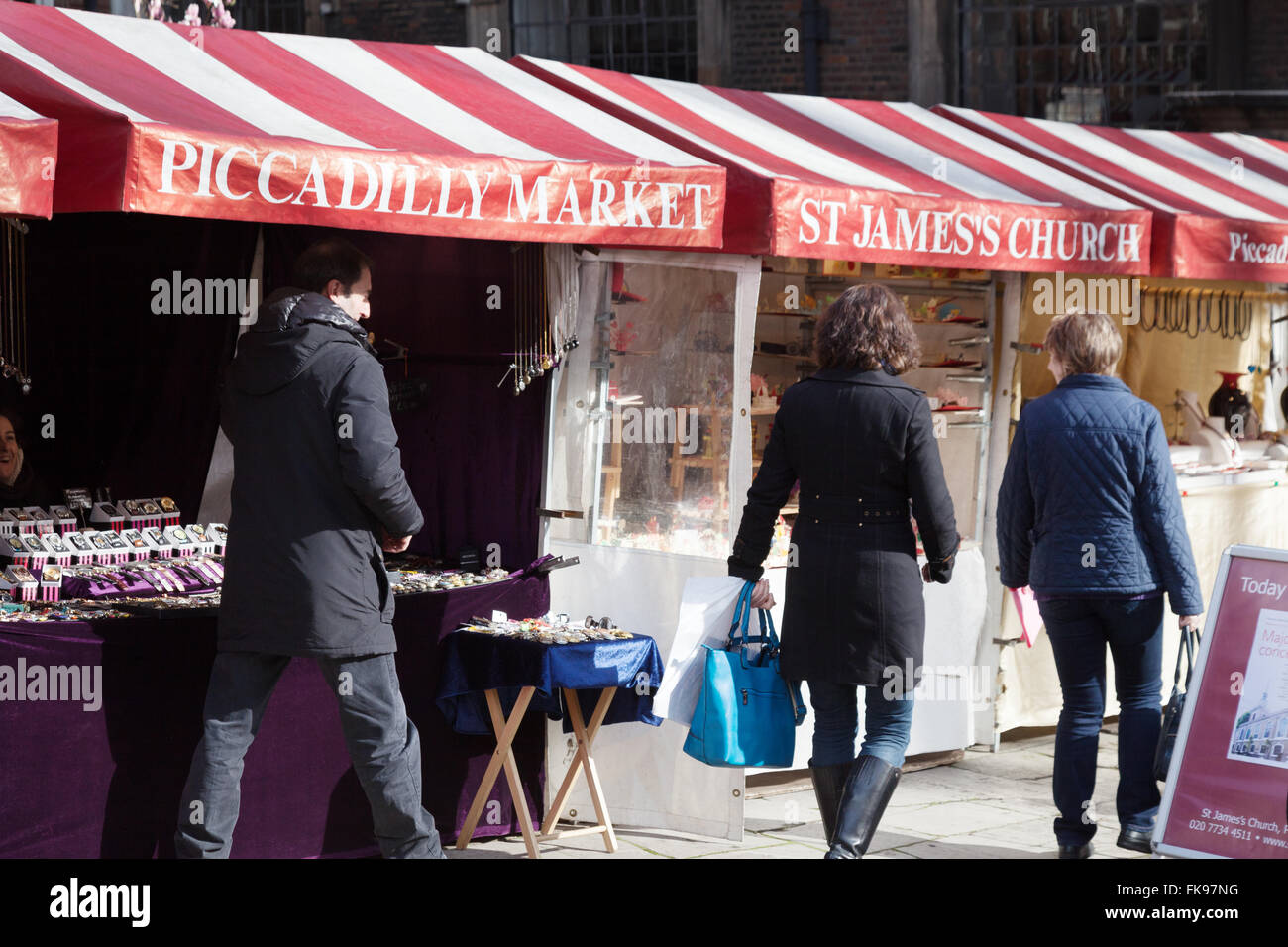 People shopping at the stalls, Piccadilly Market, St James Church, Piccadilly London UK Stock Photo