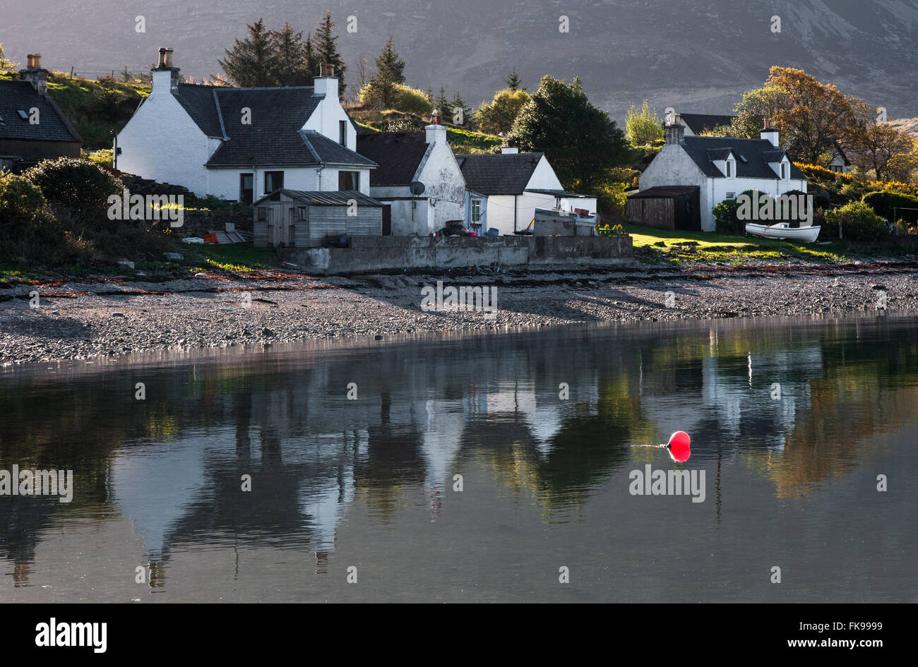 Cottages At Ardarroch Reflected In Loch Kishorn Scotland Stock